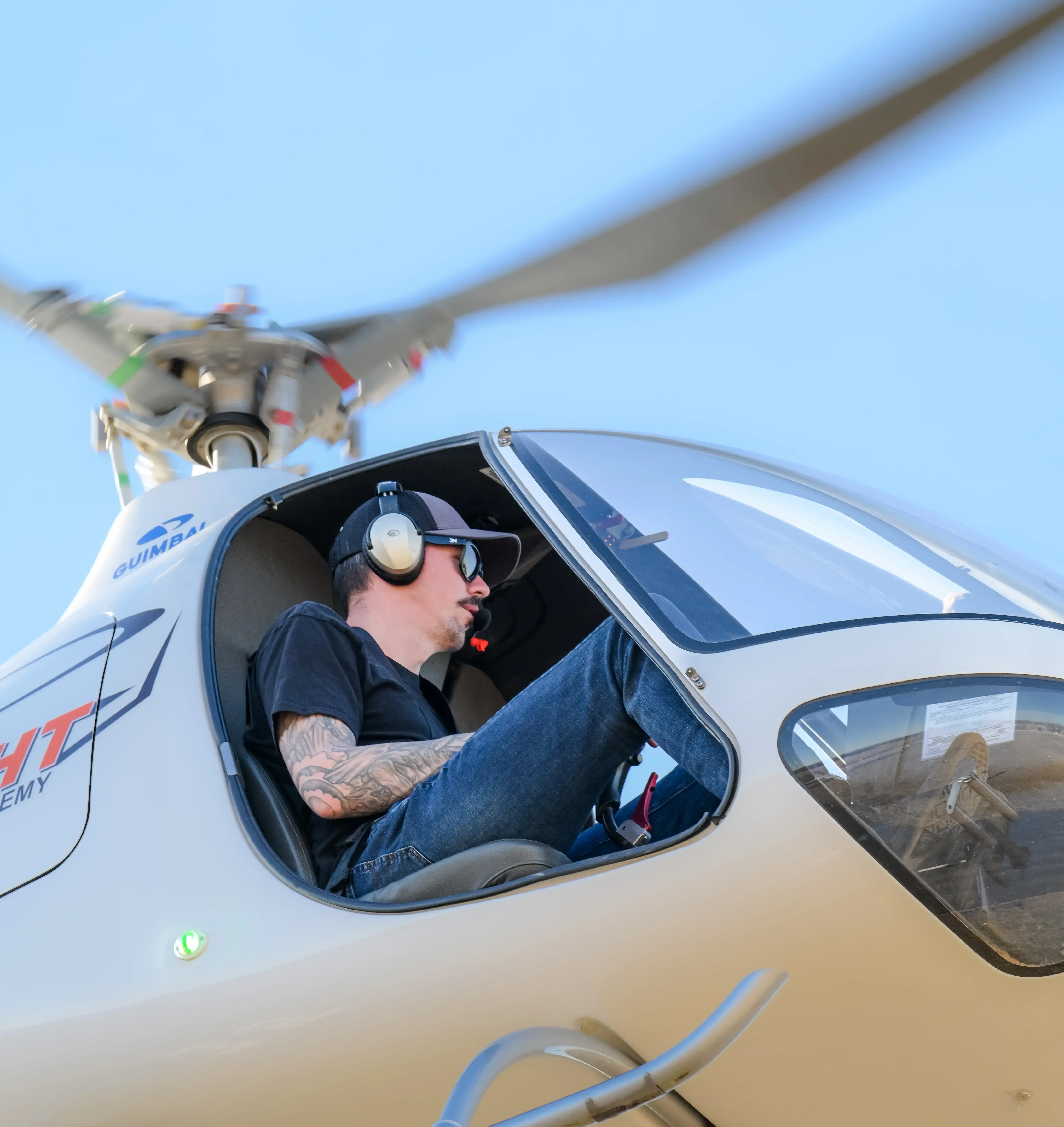 Low angle zoomed view from the right of helicopter flying